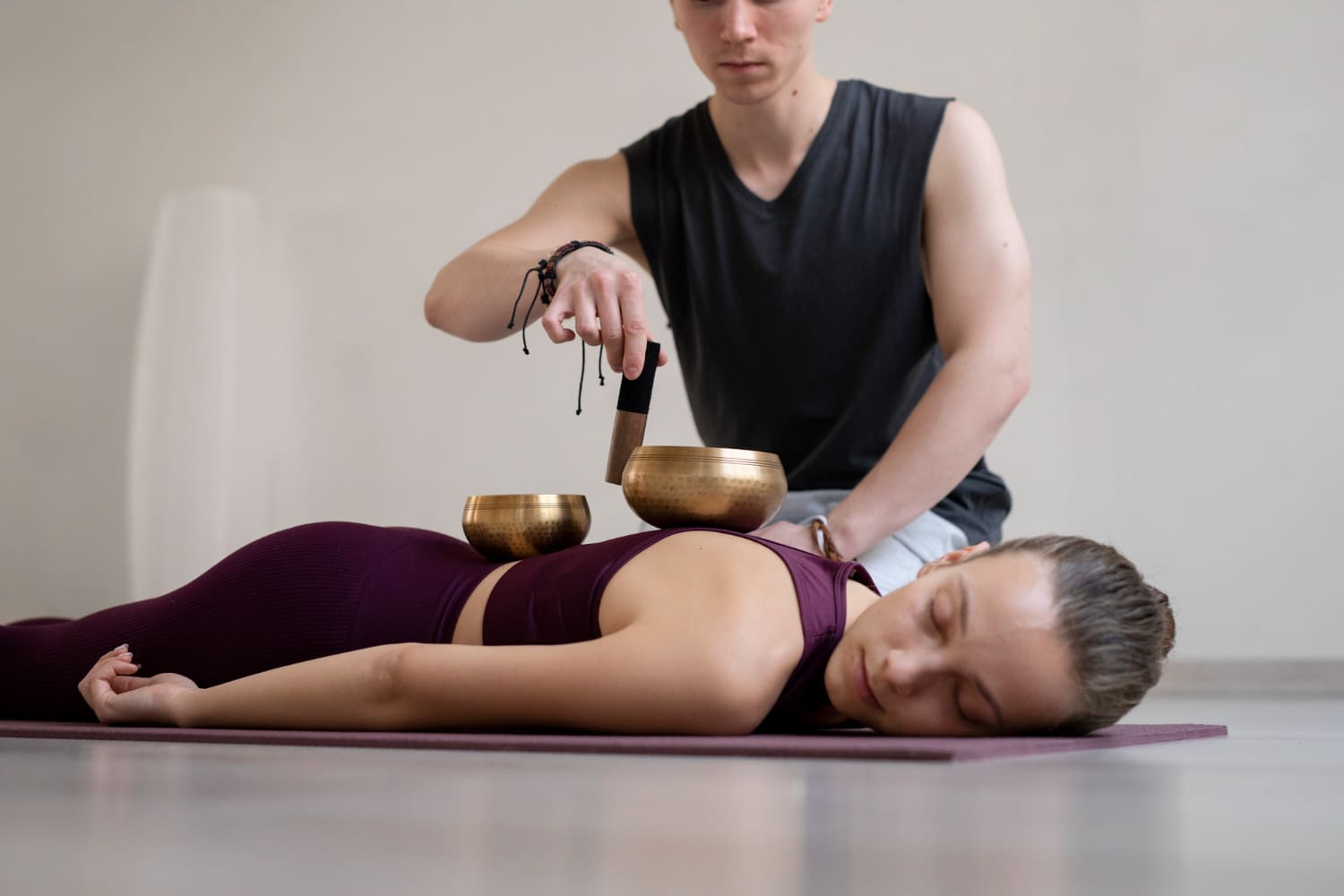 Singing bowl sound therapy on woman's back