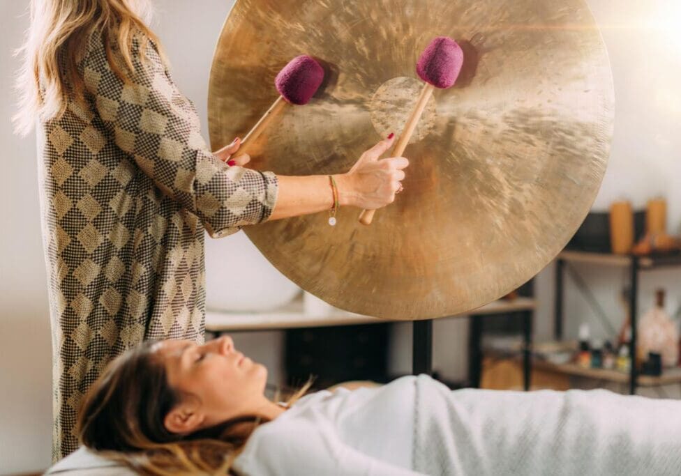 Woman receiving gong sound therapy session